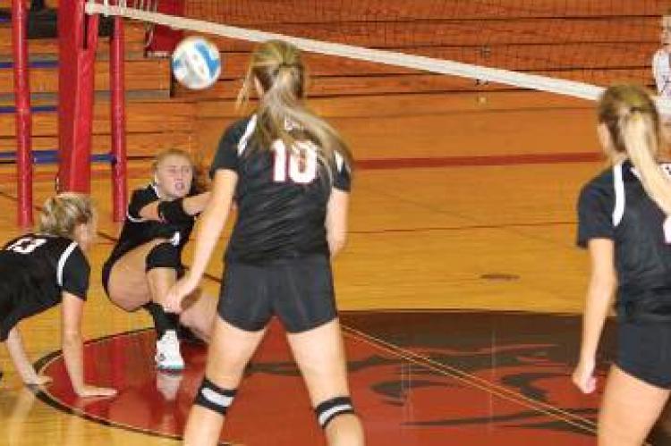 Faith Tyler gets down for the save against Gregory. Photography by Denelle Article Image Alt Text