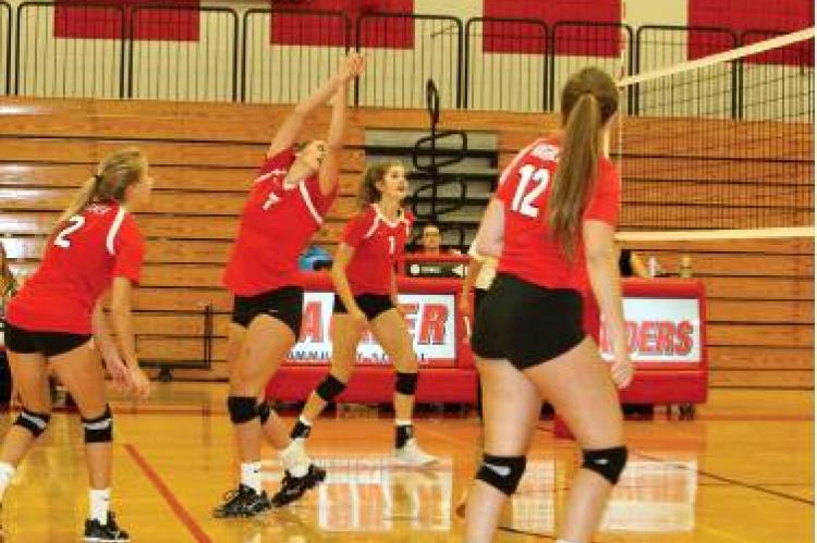 #7 Kayli Kocer safely hits it over the net backwards during the matchup with the Platte/Geddes Panthers. Article Image Alt Text