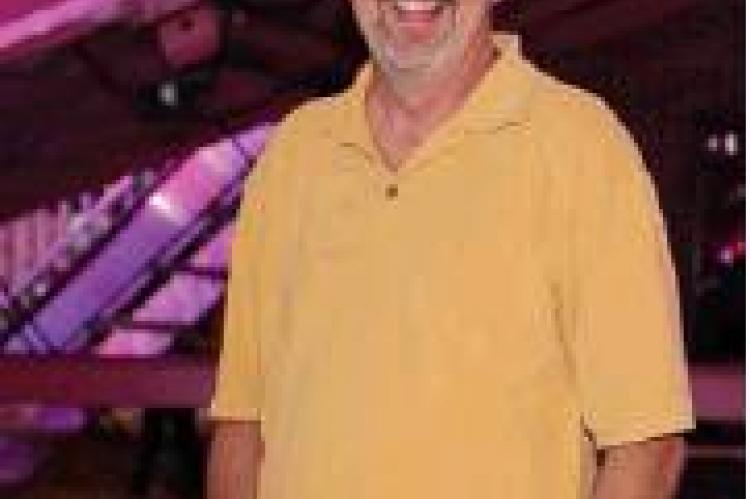 Tim Hollman relaxes on the Midway Saturday evening. Earlier in the day he took first place in the 22-Mile Bike Ride in the Labor Day Road Race. Photography by Denelle Article Image Alt Text