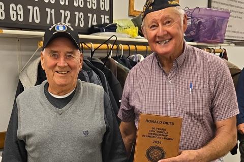Ronald Dilts being presented with his plaque by Wagner American Legion Commander, Clayton Rados.