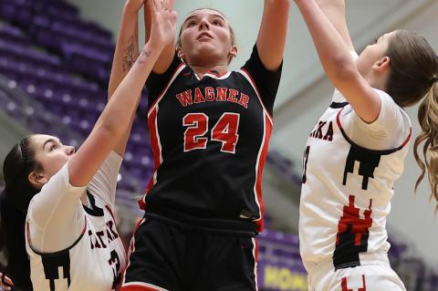 Ashlyn Koupal goes up for 2 against a tough defense.