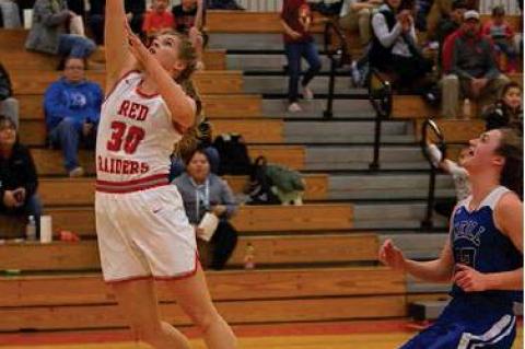 Pictured above - Maesa Dvorak goes up to add 2 points to the scoreboard  . Photo to left - Abby Brunsing goes up for the rebound  . Photos by Barb Pechous