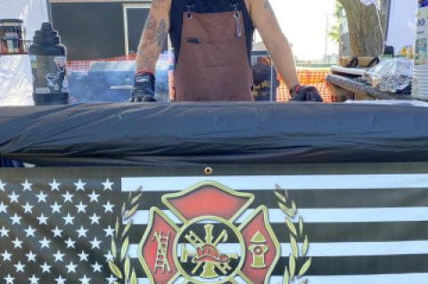 TYLER HOFER REPRESENTS THE LAKE ANDES FIRE DEPARTMENT AT THE ANNUAL FIREMAN’S RIB COOK-OFF IN FREEMAN