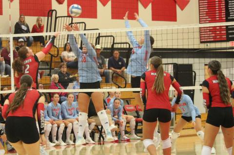 Hannah Holzbauer sends the ball over the Bon Homme defenders with her teammates ready to assist.
